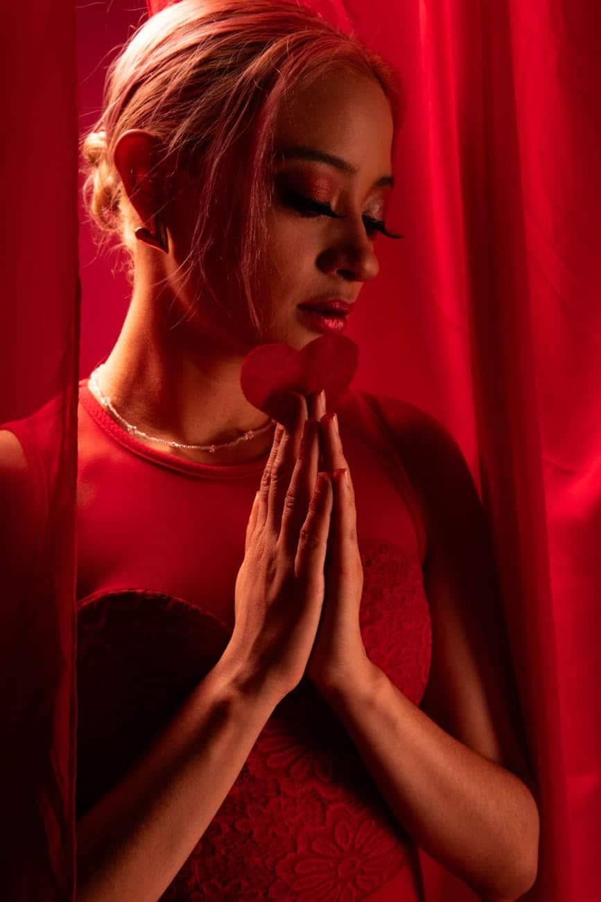 Long-lasting foundation: elegant ballerina in red with dramatic lighting