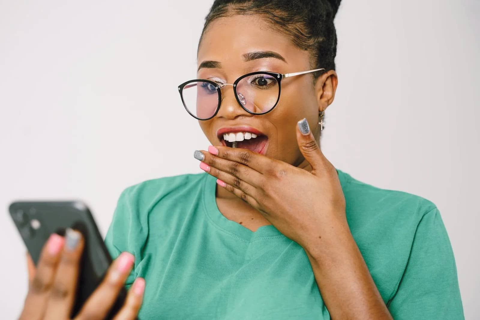 shocked woman in glasses looking at cellphone screen: Best Anti-Wrinkle Cream