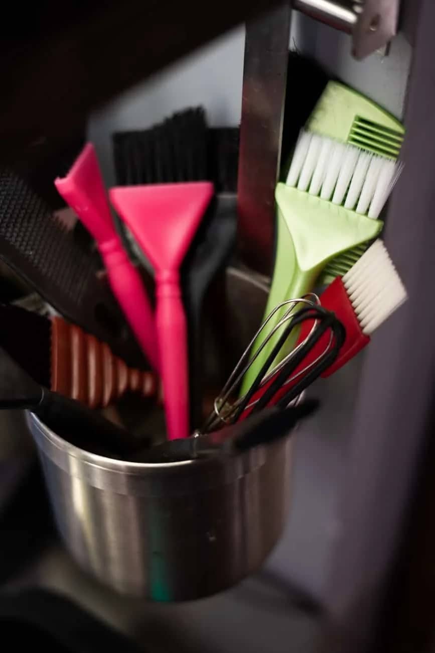 red and black handled fork in stainless steel bucket