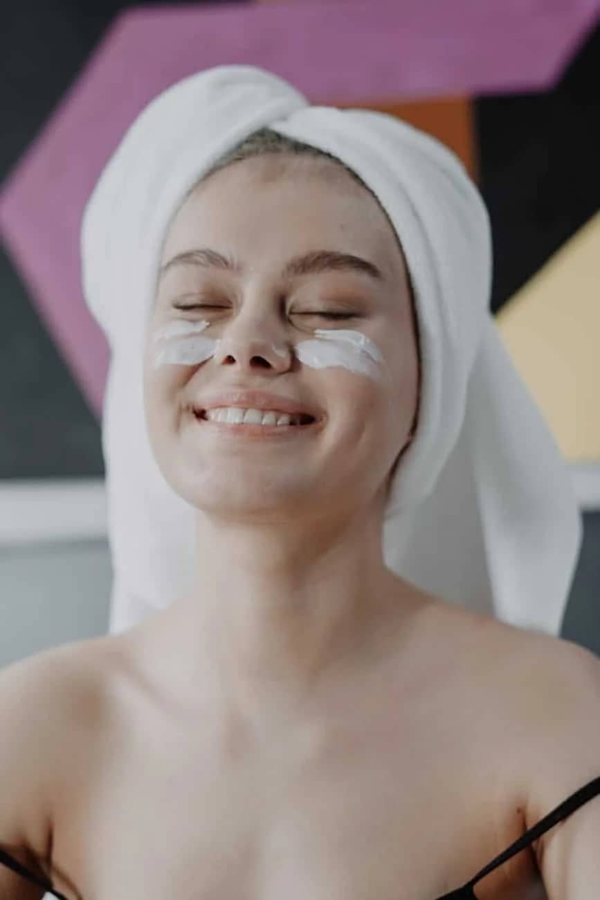 smiling woman with white towel on head: Best Anti-Wrinkle Cream