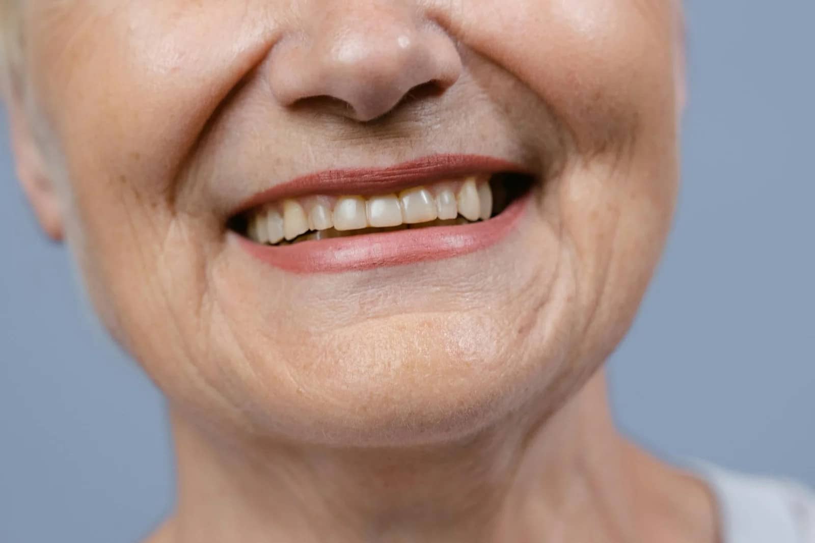 close up shot of a smiling woman: Best Anti-Wrinkle Cream