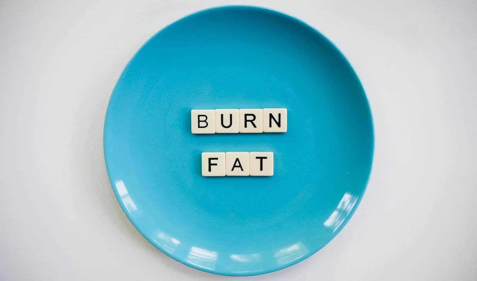 photo of a burn fat text on round blue plate - Herbs for fat loss
