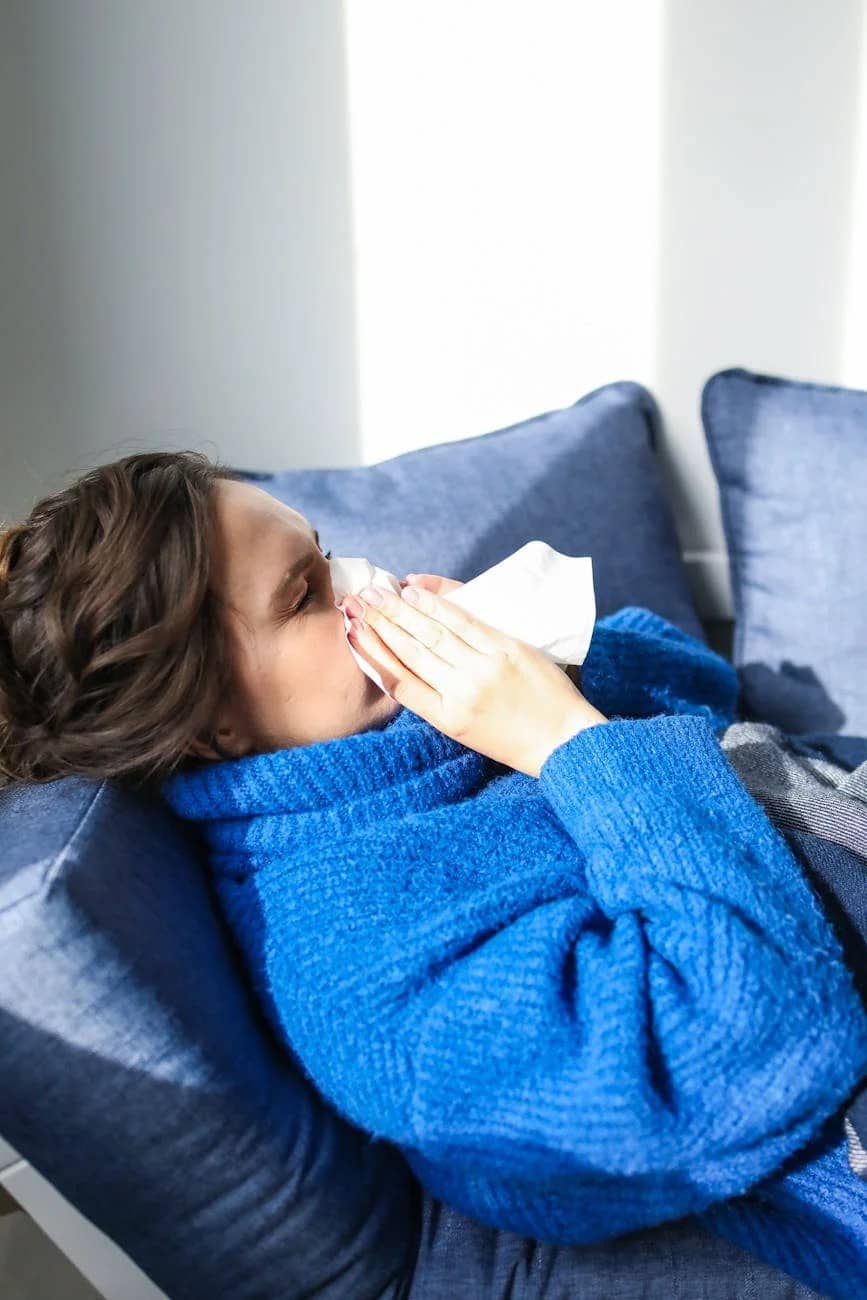 woman in blue sweater lying on bed - Herbs for fat loss