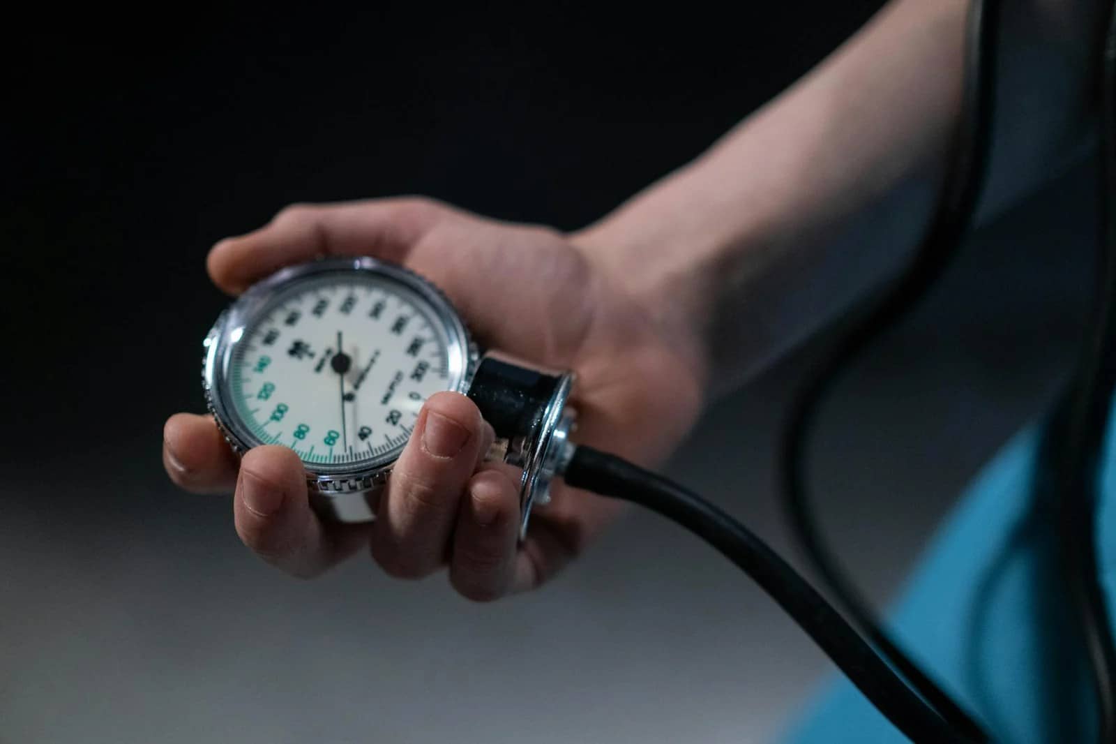 close up of person holding a sphygmomanometer