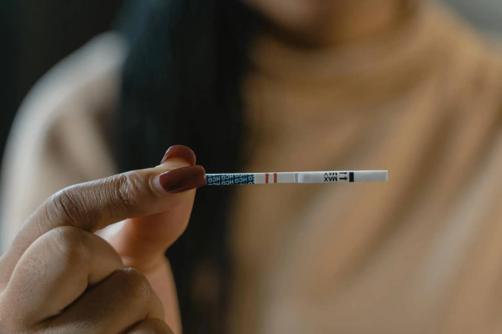 a hand holding a test strip