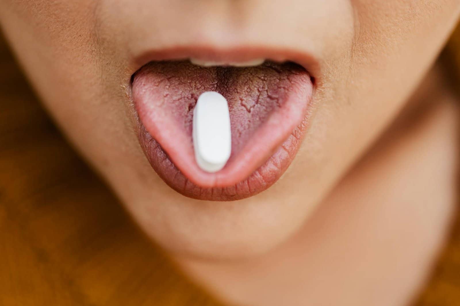 a close up shot of a person taking a medicine